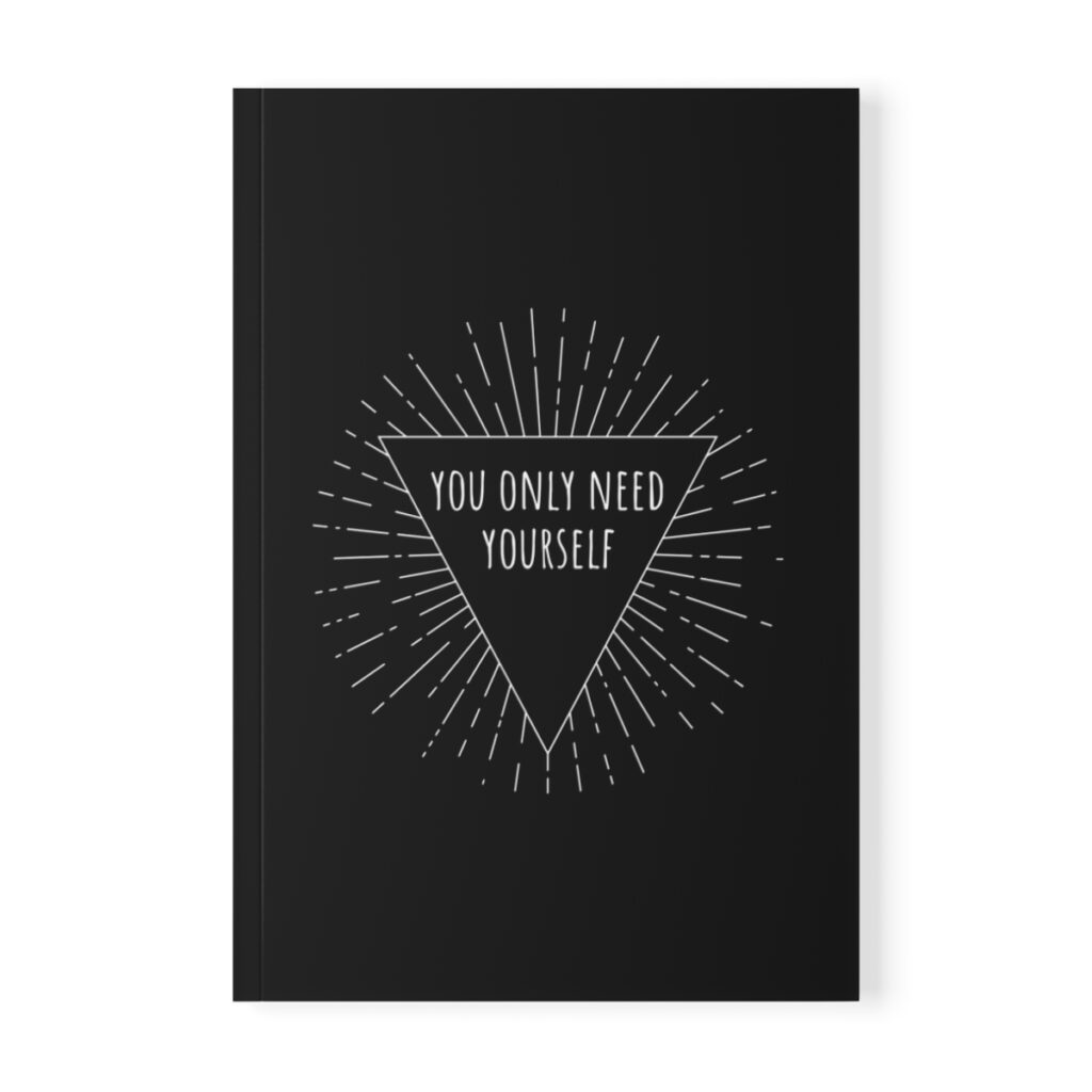Black softcover notebook with a white triangle in the center. Inside the triangle, the text reads "You Only Need Yourself" with radiating lines around it, conveying motivation by iziiexpressions.com