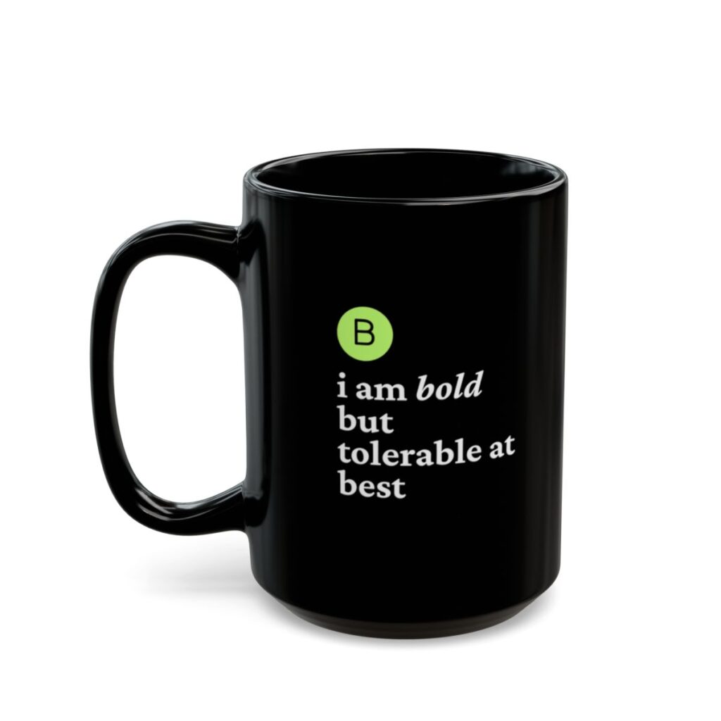 A black coffee mug features the quote, "B. I am bold but tolerable at best," in white text with a green circle around a bold "B."