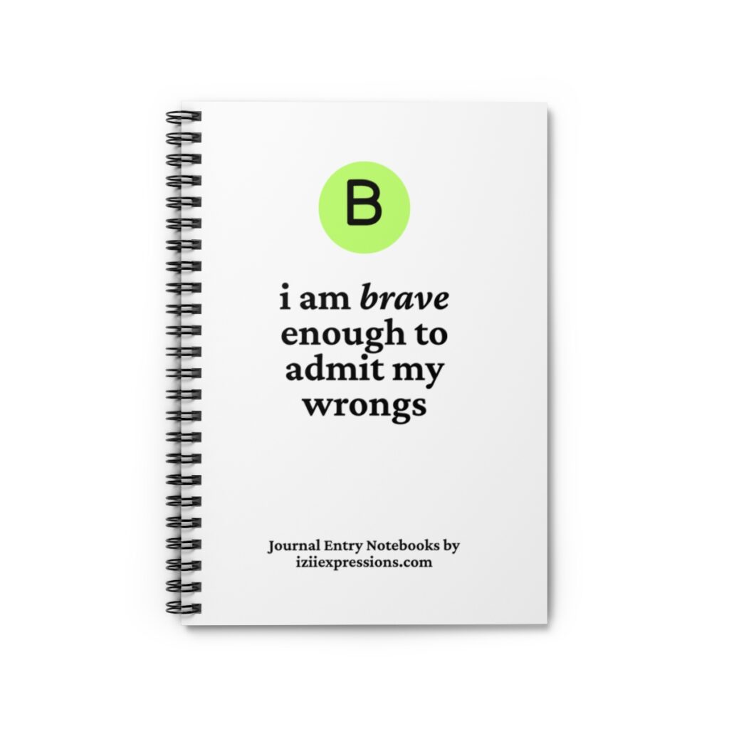 Spiral-bound notebook with a white cover. A green circle with a black "B" at the top, followed by the text: "i am brave enough to admit my wrongs."