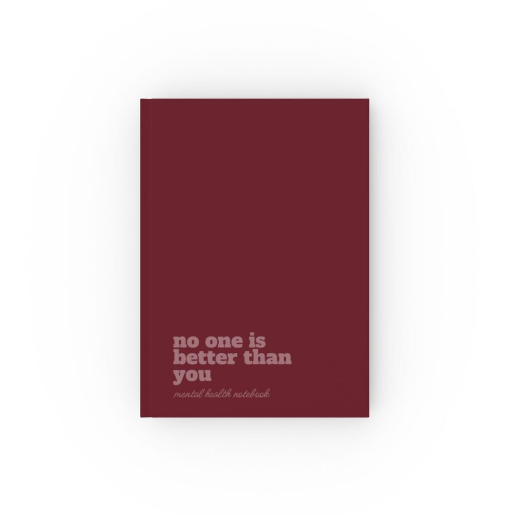 An burgundy hardcover notebook cover with bold rose text reading "no one is better than you." Below, smaller text says "mental health notebook." The tone is empowering by iziiexpressions.com