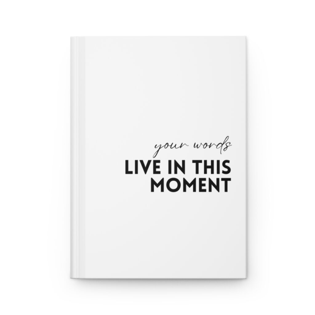 White book cover with a black title "live in the moment" in white, handwritten style font, conveying introspection and personal reflection by iziiexpressions.com